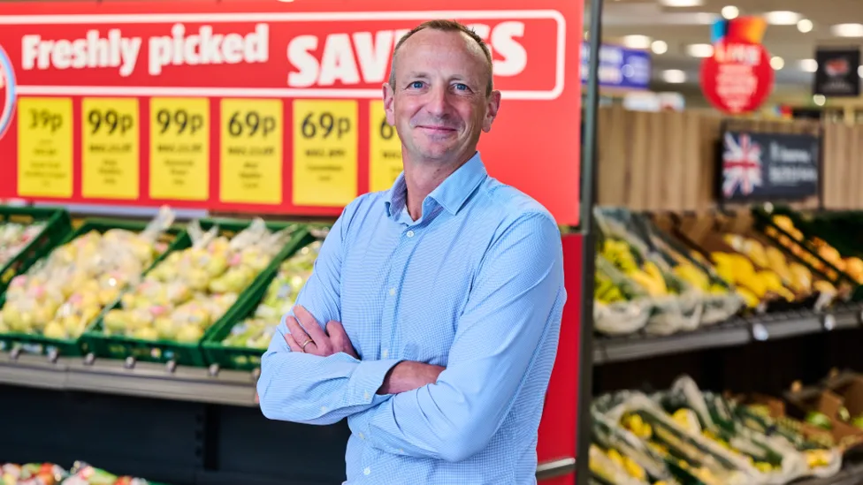 Aldi boss says, “shoppers are treating themselves … as cost of living pressures start to ease”